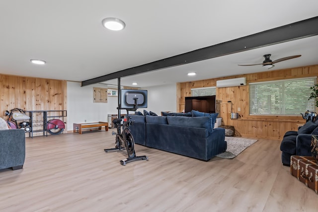 7 Papoose Island Rd, Raymond, ME 04071 - living room with wooden walls, a wall mounted air conditioner, wood finished floors, and a ceiling fan