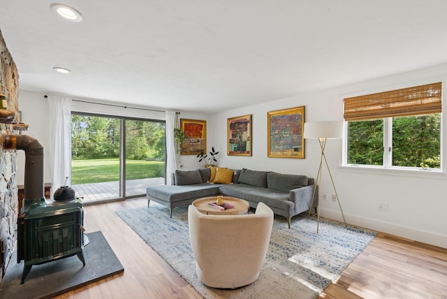 2 Far View Cir, Saco, ME 04072 - living area with healthy amount of natural light, a wood stove, wood finished floors, and recessed lighting