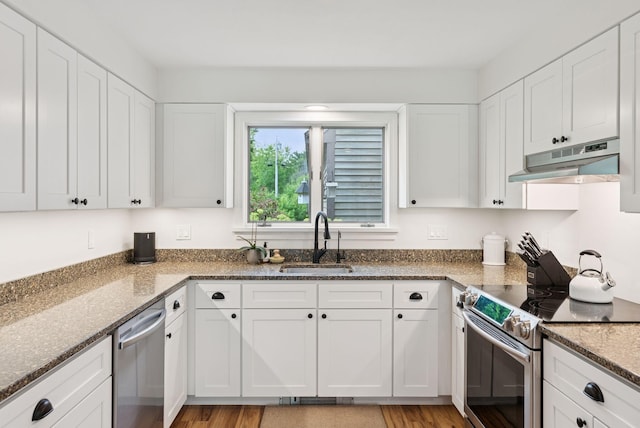 2 Far View Cir, Saco, ME 04072 - kitchen with appliances with stainless steel finishes, under cabinet range hood, white cabinetry, and dark stone counters