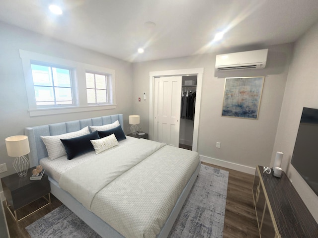 106 Cumberland Ave Unit 201, Portland, ME 04101 - bedroom with a wall mounted AC, dark wood-type flooring, a closet, and recessed lighting