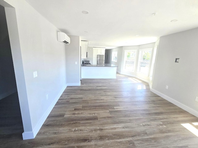 106 Cumberland Ave Unit 201, Portland, ME 04101 - unfurnished living room with a wall mounted air conditioner and wood finished floors