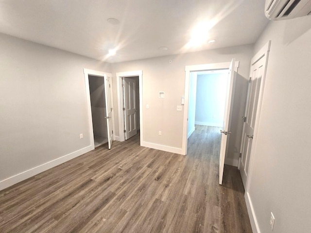 106 Cumberland Ave Unit 201, Portland, ME 04101 - unfurnished bedroom featuring an AC wall unit and wood finished floors