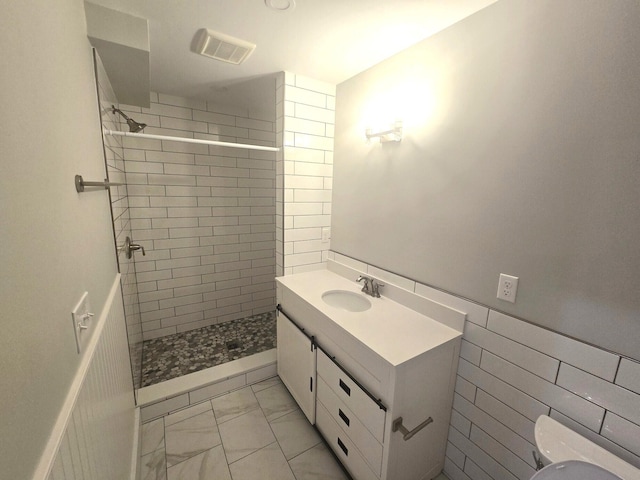 106 Cumberland Ave Unit 201, Portland, ME 04101 - full bathroom with tiled shower, marble look tile flooring, and vanity