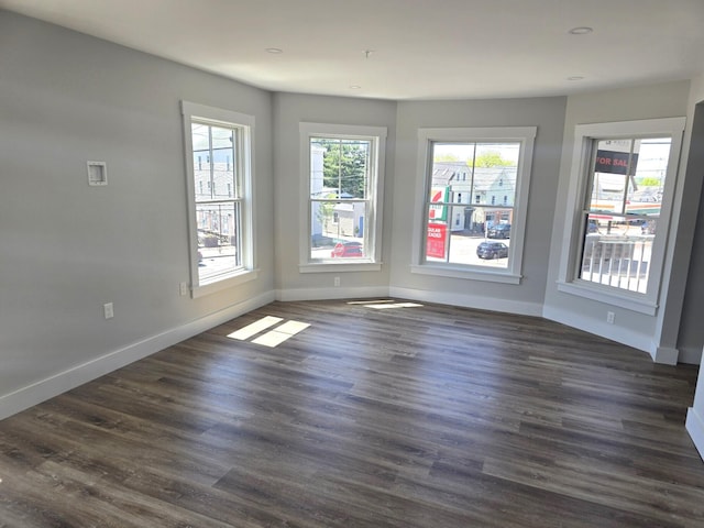 106 Cumberland Ave Unit 201, Portland, ME 04101 - unfurnished room featuring baseboards and dark wood-style floors