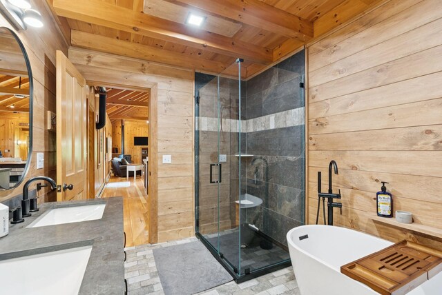 7 Coven Hill Ln, South Bristol, ME 04568 - bathroom featuring wood walls, a wooden ceiling with exposed beams, a freestanding tub, a stall shower, and double vanity