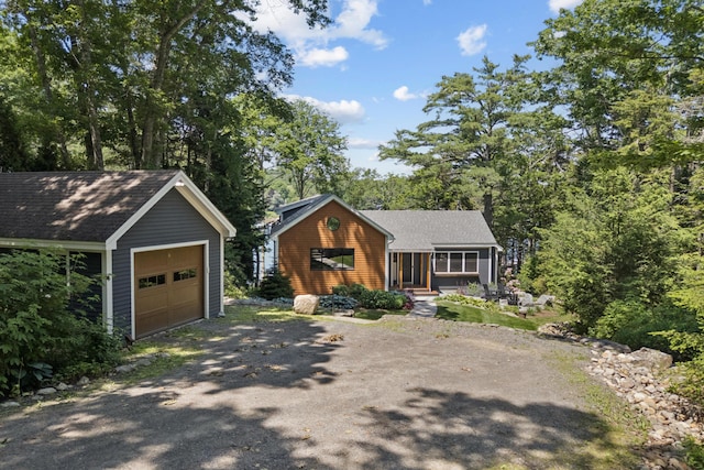 7 Coven Hill Ln, South Bristol, ME 04568 - view of front facade with asphalt driveway, an outbuilding, and a detached garage