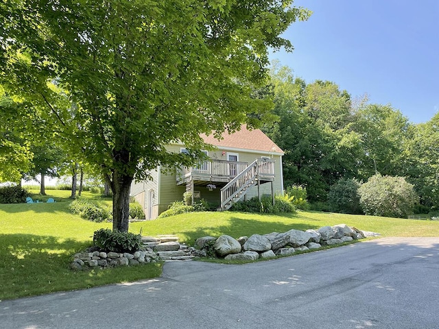 232 Hatch Rd, Prospect, ME 04981 - view of front of house with stairs, a front lawn, and a wooden deck