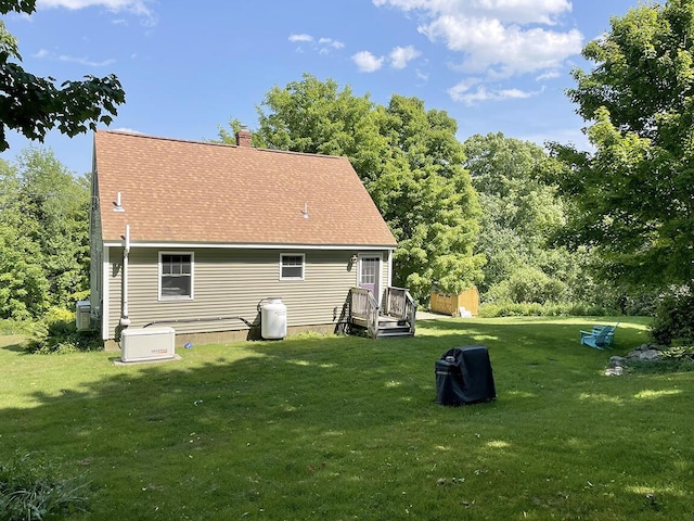 232 Hatch Rd, Prospect, ME 04981 - rear view of property featuring a lawn, a chimney, and roof with shingles
