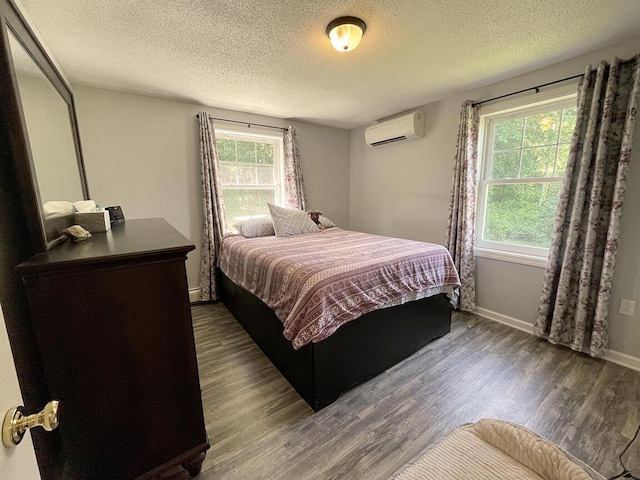 232 Hatch Rd, Prospect, ME 04981 - bedroom featuring a wall mounted air conditioner, dark wood-type flooring, and a textured ceiling