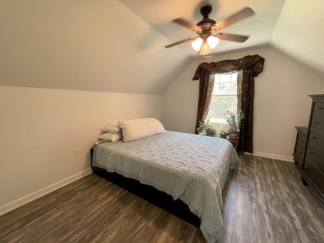 232 Hatch Rd, Prospect, ME 04981 - bedroom with dark wood-type flooring, vaulted ceiling, a ceiling fan, and a textured ceiling