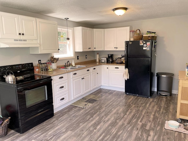 232 Hatch Rd, Prospect, ME 04981 - kitchen with black appliances, under cabinet range hood, dark wood finished floors, white cabinets, and a textured ceiling