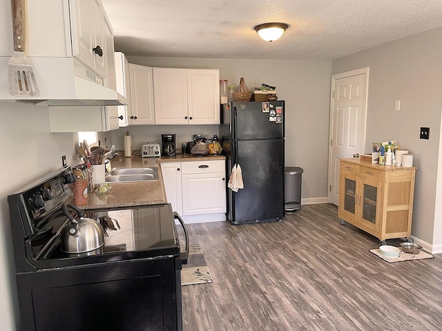 232 Hatch Rd, Prospect, ME 04981 - kitchen with black appliances, under cabinet range hood, white cabinets, dark wood-style flooring, and a textured ceiling