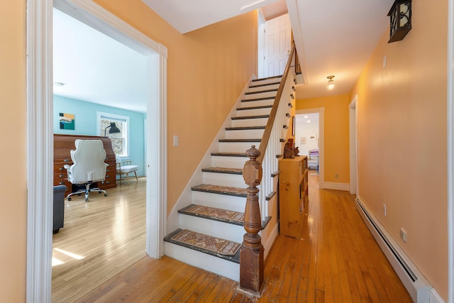 390 Front St, Bath, ME 04530 - stairs with baseboard heating and wood-type flooring