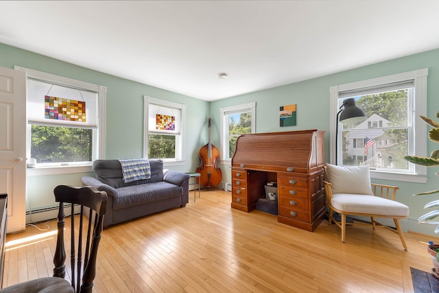 390 Front St, Bath, ME 04530 - living area featuring a baseboard heating unit, plenty of natural light, and light wood-type flooring