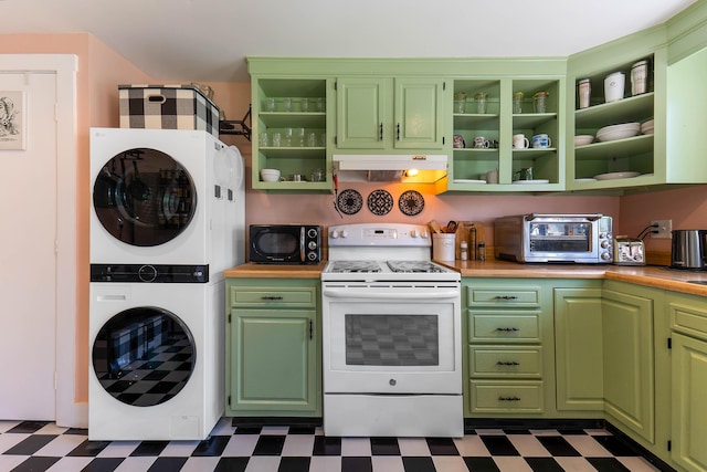 390 Front St, Bath, ME 04530 - kitchen featuring white range with electric stovetop, stacked washer and clothes dryer, dark flooring, and under cabinet range hood