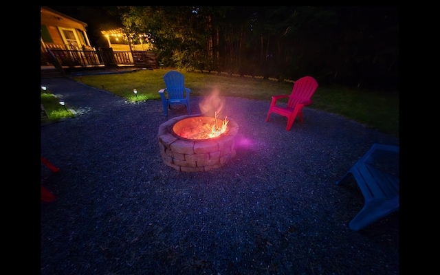 1093 N Chester Rd, Chester, ME 04457 - yard at twilight with a fire pit