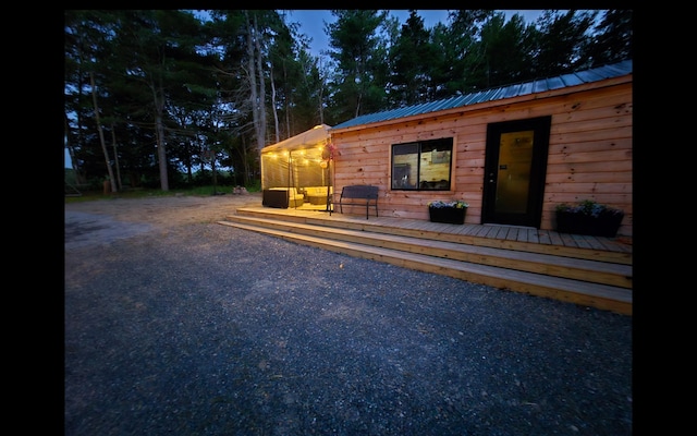 1093 N Chester Rd, Chester, ME 04457 - view of front facade featuring a wooden deck and a metal roof