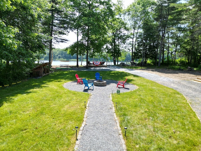 1093 N Chester Rd, Chester, ME 04457 - view of grassy yard featuring a fire pit and a water view