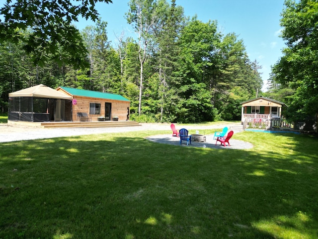 1093 N Chester Rd, Chester, ME 04457 - view of green lawn with a fire pit, a gazebo, and an outdoor structure