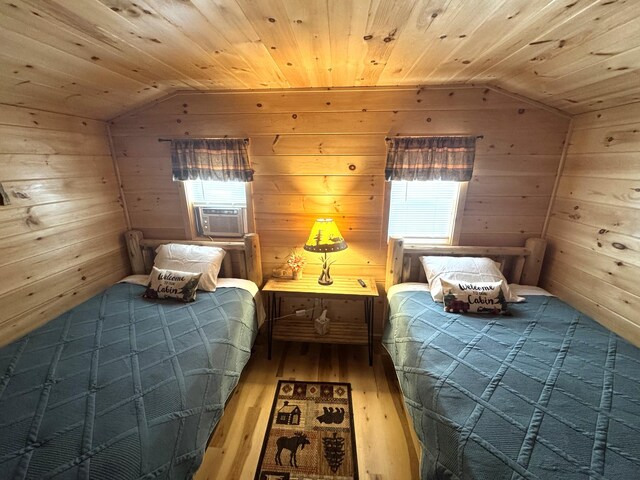 1093 N Chester Rd, Chester, ME 04457 - bedroom featuring vaulted ceiling, cooling unit, wooden walls, wood-type flooring, and wooden ceiling