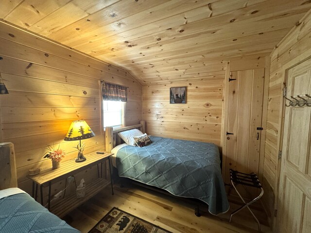 1093 N Chester Rd, Chester, ME 04457 - bedroom with wood walls, wood finished floors, wooden ceiling, and lofted ceiling