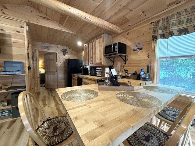 1093 N Chester Rd, Chester, ME 04457 - dining area with wooden walls, light wood-style floors, and wooden ceiling