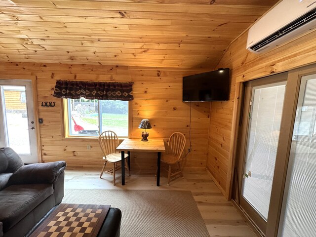 1093 N Chester Rd, Chester, ME 04457 - living room with a wall unit AC, wood walls, light wood finished floors, vaulted ceiling, and wood ceiling