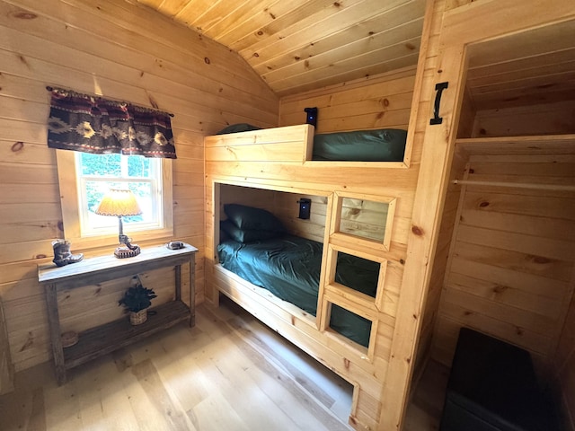 1093 N Chester Rd, Chester, ME 04457 - bedroom featuring vaulted ceiling, wood walls, wood finished floors, and wooden ceiling