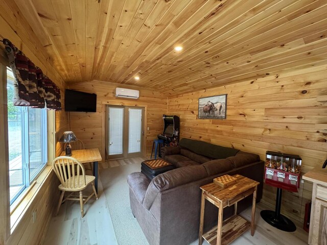 1093 N Chester Rd, Chester, ME 04457 - living room featuring vaulted ceiling, wooden walls, a wall unit AC, wood finished floors, and french doors