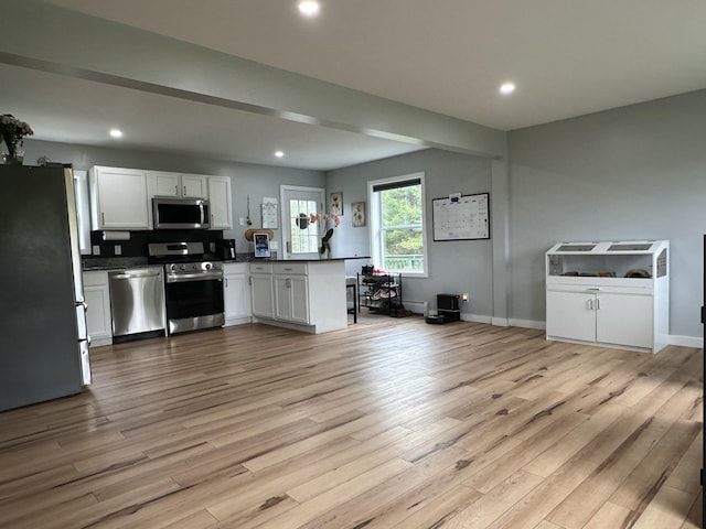 64 Litchfield Rd, Bowdoin, ME 04287 - kitchen with stainless steel appliances, a peninsula, dark countertops, light wood-style floors, and recessed lighting
