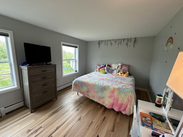 64 Litchfield Rd, Bowdoin, ME 04287 - bedroom with a baseboard heating unit and light wood-style floors