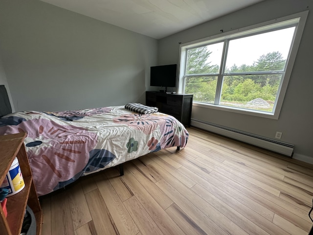 64 Litchfield Rd, Bowdoin, ME 04287 - bedroom with a baseboard heating unit and wood finished floors