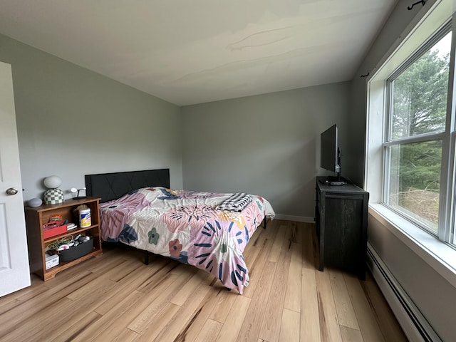 64 Litchfield Rd, Bowdoin, ME 04287 - bedroom with light wood-style flooring and a baseboard radiator