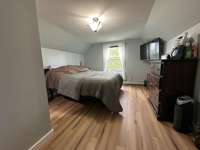 64 Litchfield Rd, Bowdoin, ME 04287 - bedroom with a baseboard heating unit, lofted ceiling, and light wood-style floors