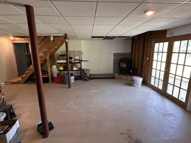 64 Litchfield Rd, Bowdoin, ME 04287 - basement featuring stairway, a wood stove, a drop ceiling, and french doors