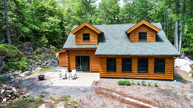 51 Short Point Way, Orland, ME 04472 - rear view of property featuring an outdoor fire pit, a shingled roof, and a patio