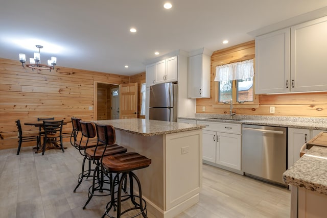 51 Short Point Way, Orland, ME 04472 - kitchen with stainless steel appliances, a kitchen island, a chandelier, white cabinetry, and recessed lighting