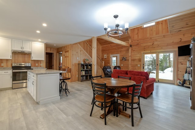 51 Short Point Way, Orland, ME 04472 - dining area with wood walls, a chandelier, stairway, and recessed lighting