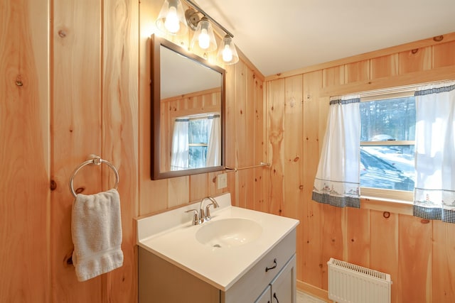 51 Short Point Way, Orland, ME 04472 - bathroom featuring radiator, vanity, healthy amount of natural light, and wood walls