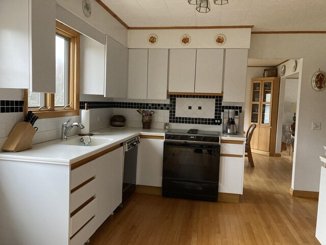 1 Francis Rd, Steuben, ME 04680 - kitchen featuring black appliances, light countertops, crown molding, and light wood-style floors