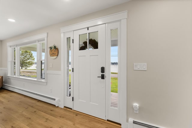 352 River Rd, Eliot, ME 03903 - entrance foyer featuring baseboard heating, light wood finished floors, wainscoting, recessed lighting, and a water view