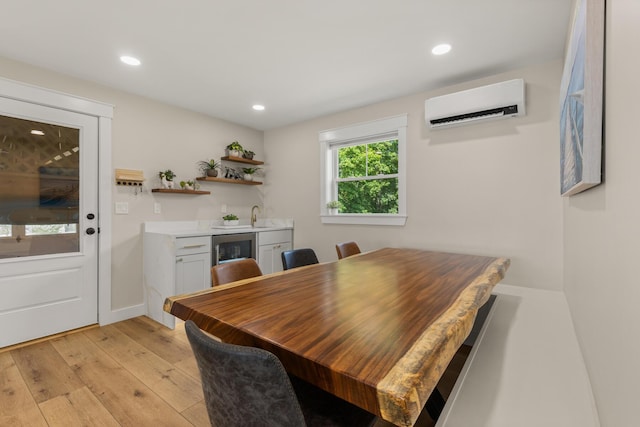 352 River Rd, Eliot, ME 03903 - dining space with a wall unit AC, wine cooler, light wood-style floors, and recessed lighting