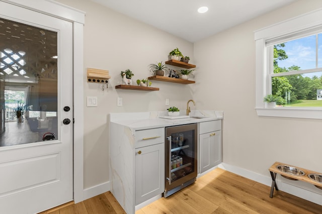 352 River Rd, Eliot, ME 03903 - indoor wet bar featuring beverage cooler, light wood-type flooring, and plenty of natural light