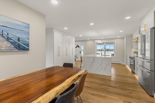352 River Rd, Eliot, ME 03903 - dining room featuring light wood finished floors, a baseboard heating unit, recessed lighting, and a chandelier