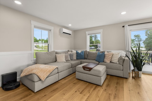 352 River Rd, Eliot, ME 03903 - living area featuring an AC wall unit, light wood-type flooring, and recessed lighting