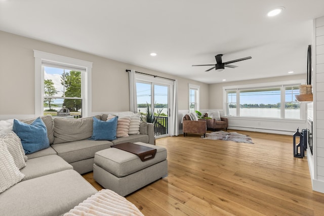 352 River Rd, Eliot, ME 03903 - living room with a baseboard heating unit, light wood-style floors, a ceiling fan, recessed lighting, and a water view