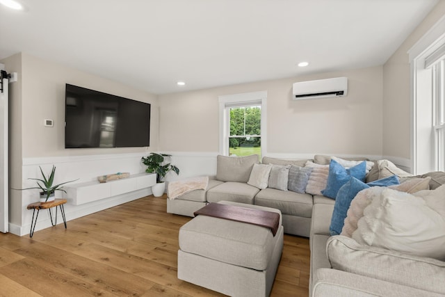 352 River Rd, Eliot, ME 03903 - living room with a wall mounted AC, wood finished floors, and recessed lighting