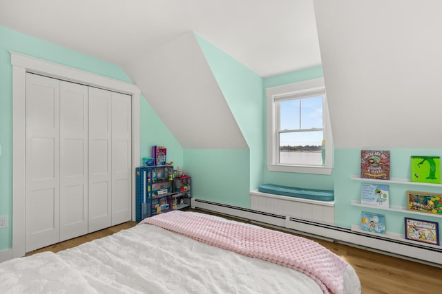 352 River Rd, Eliot, ME 03903 - bedroom featuring baseboard heating, lofted ceiling, wood finished floors, and a closet