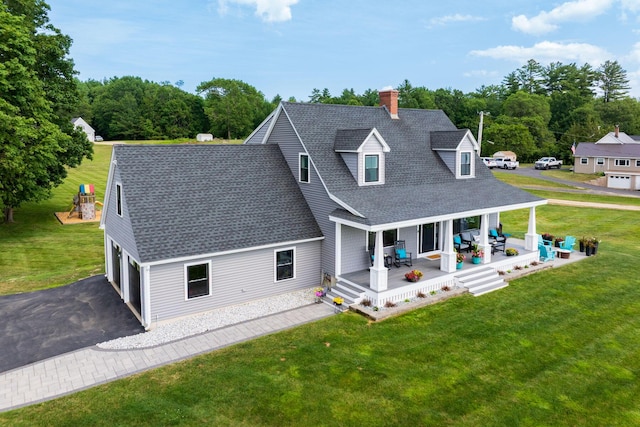 352 River Rd, Eliot, ME 03903 - view of front of home featuring roof with shingles, a chimney, asphalt driveway, a front yard, and a porch