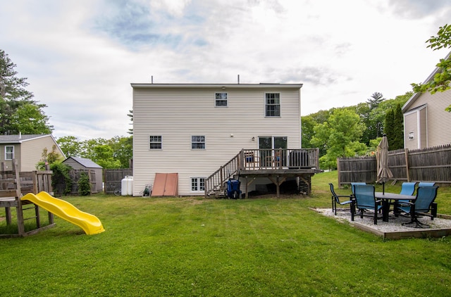 9 St James Pl, Lewiston, ME 04240 - rear view of house featuring a deck, a fenced backyard, and a playground